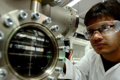 Man in white lab coat with protective eyewear