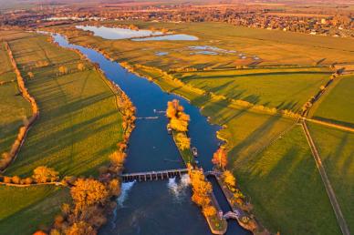 Aerial photography of river and open field during daytime photo by Lawrence Hookham on Unsplash