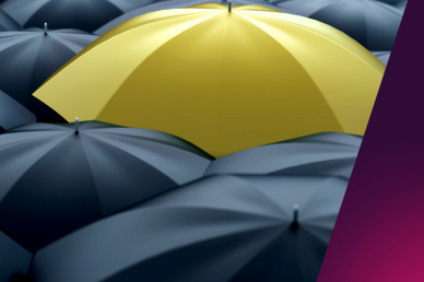 A single yellow umbrella in a sea of black umbrellas signifying difference 