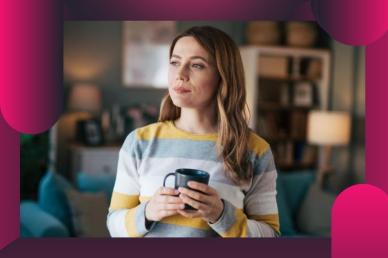 A thoughtful woman in a striped sweater holding a mug while contemplating indoors