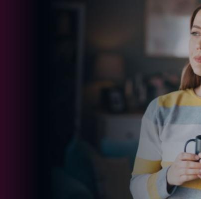 A thoughtful woman in a striped sweater with a mug